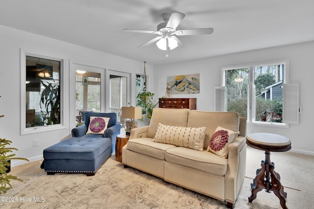 living room featuring light carpet and ceiling fan