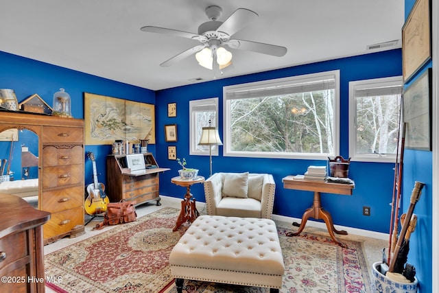 living area featuring ceiling fan and carpet floors