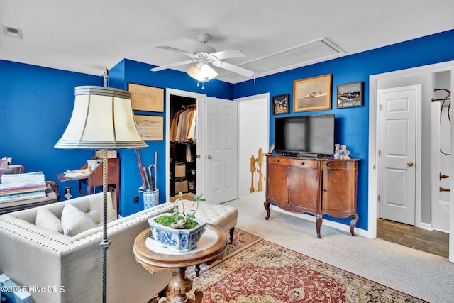 carpeted living room featuring ceiling fan