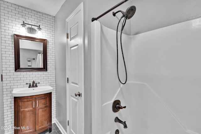 bathroom featuring vanity, tasteful backsplash, and bathing tub / shower combination