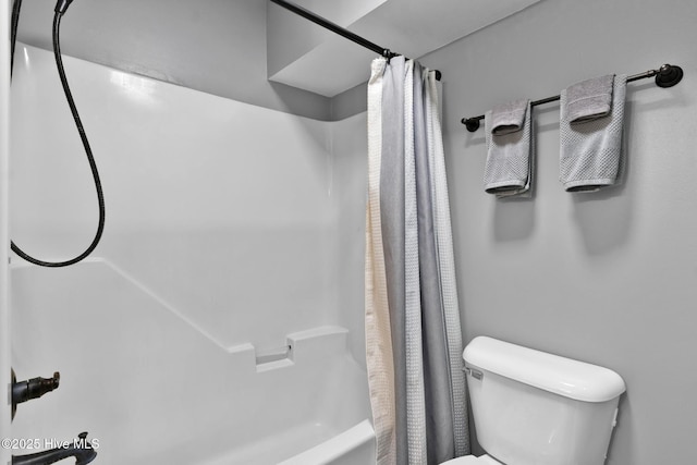 bathroom with shower / bath combo and toilet