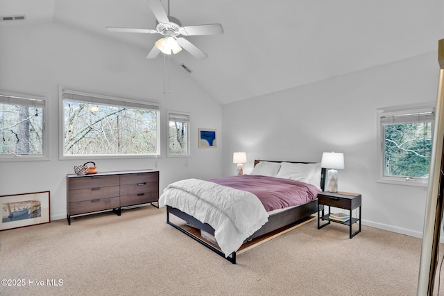 carpeted bedroom with ceiling fan and vaulted ceiling