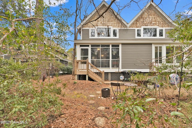 rear view of property with a sunroom