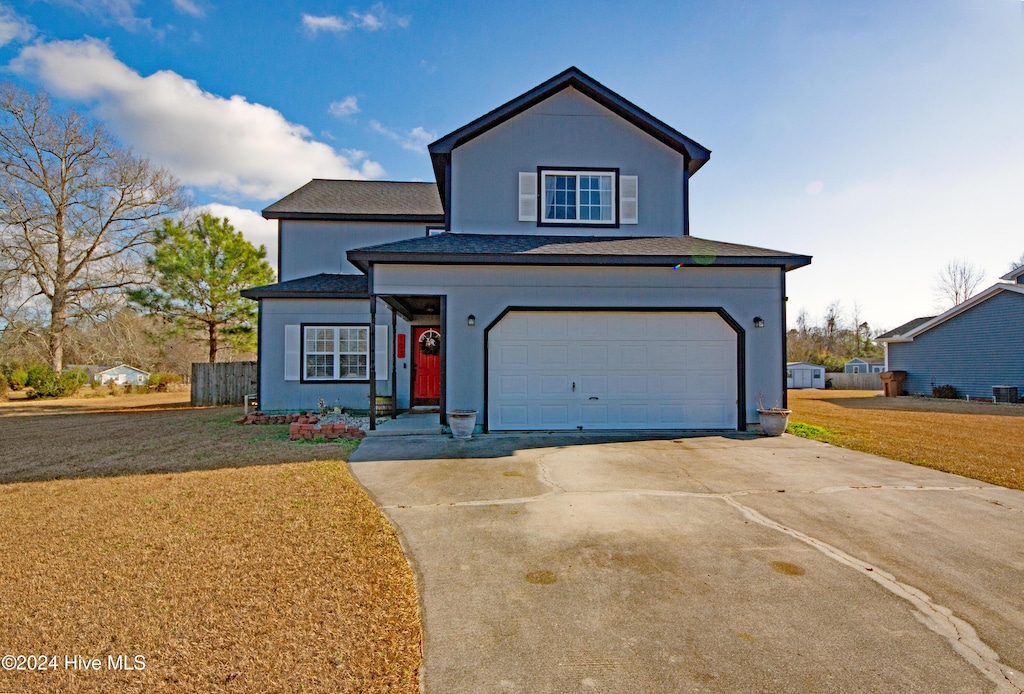 view of front property featuring a garage and a front lawn