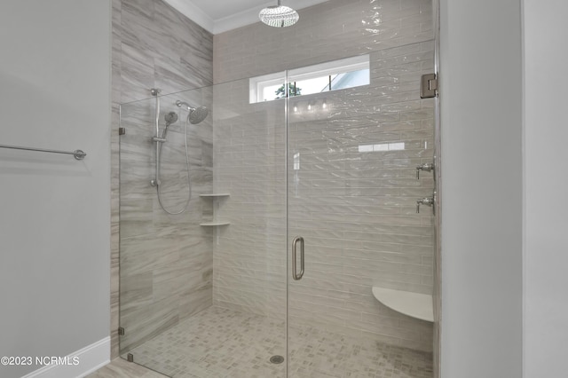 bathroom featuring crown molding and a shower with shower door