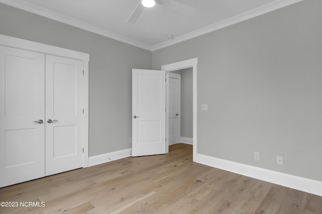 unfurnished bedroom featuring crown molding, a closet, ceiling fan, and light hardwood / wood-style floors