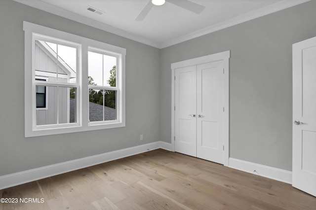 unfurnished bedroom with a closet, light hardwood / wood-style flooring, ceiling fan, and ornamental molding