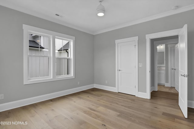 interior space featuring light hardwood / wood-style floors and ornamental molding