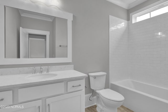 full bathroom featuring hardwood / wood-style floors, vanity, toilet, and tiled shower / bath combo