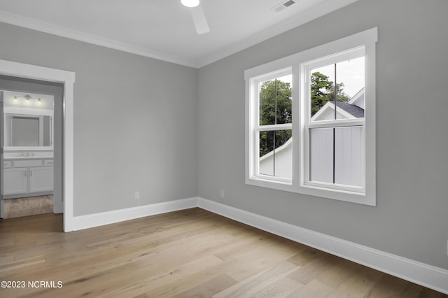 unfurnished room with ceiling fan, sink, light hardwood / wood-style floors, and ornamental molding