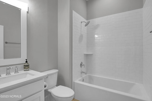 full bathroom with vanity, toilet, and tiled shower / bath