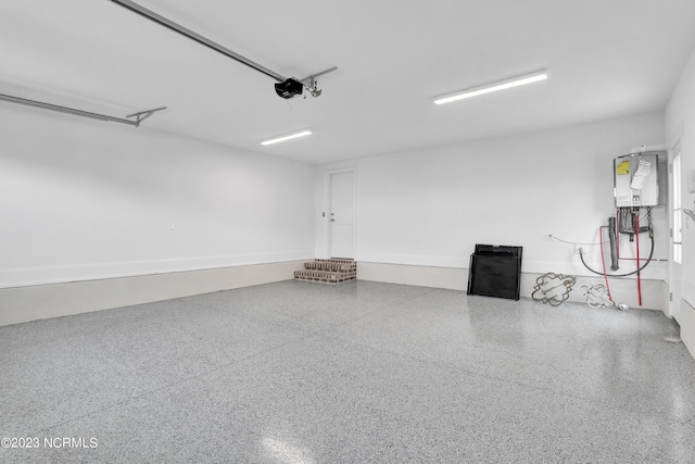 garage featuring water heater and a garage door opener