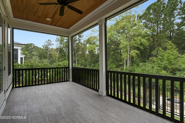 unfurnished sunroom with ceiling fan and wooden ceiling