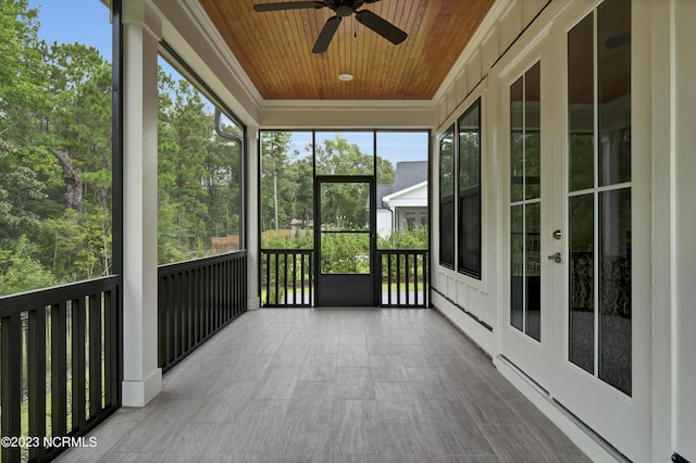 unfurnished sunroom with ceiling fan and wooden ceiling