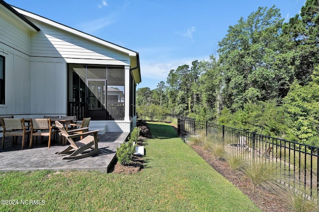 view of yard featuring a sunroom and a patio