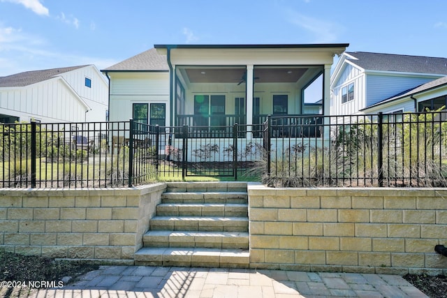 view of front of property featuring ceiling fan and a sunroom