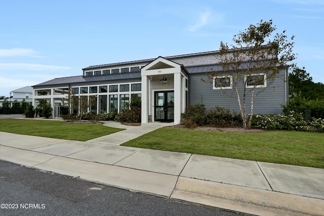 view of front of home featuring french doors and a front lawn