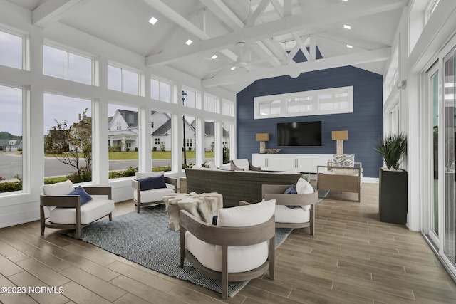 interior space featuring vaulted ceiling with beams and ceiling fan