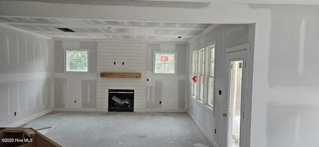 unfurnished living room with crown molding and a fireplace