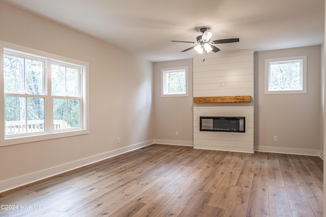 1725 Longleaf Dr E, Pinehurst, NC 28374 - unfurnished living room with baseboards, a ceiling fan, a fireplace, and hardwood / wood-style flooring