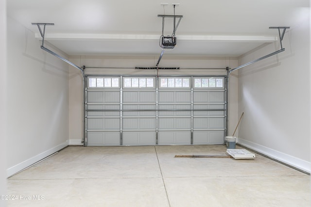 garage featuring a garage door opener and baseboards