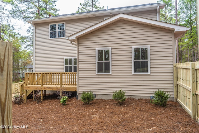 rear view of house featuring a wooden deck