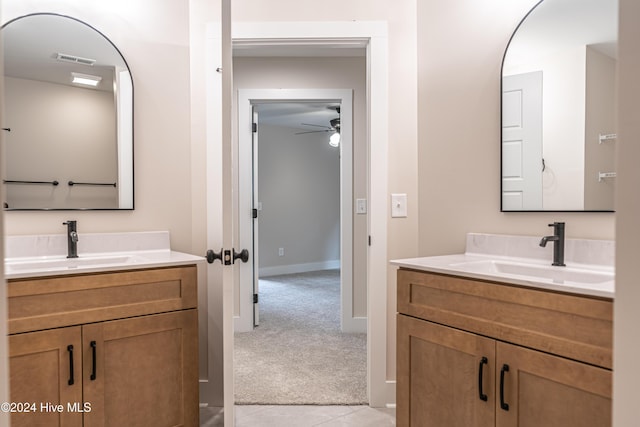 bathroom with a sink, visible vents, and two vanities