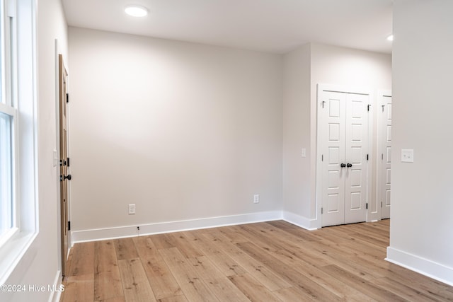 unfurnished room featuring light wood-style floors and baseboards