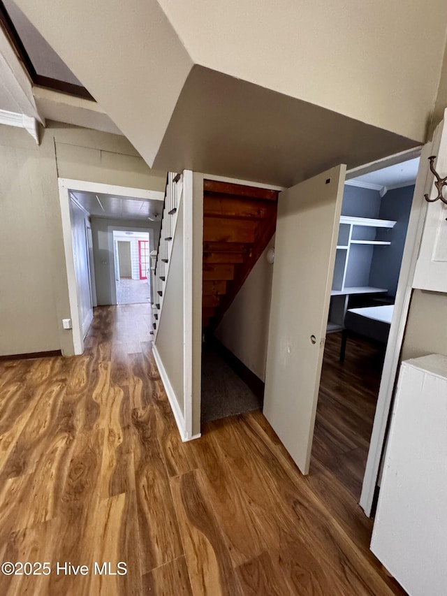 hallway featuring hardwood / wood-style flooring and vaulted ceiling