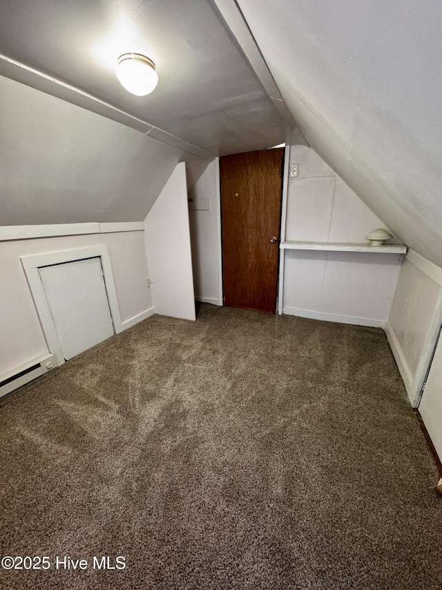 bonus room with dark colored carpet, lofted ceiling, and a baseboard radiator