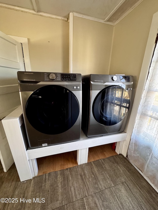 laundry room featuring washing machine and clothes dryer and dark hardwood / wood-style flooring