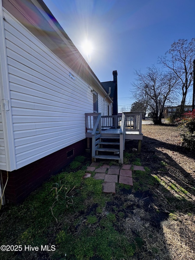 view of side of home featuring a wooden deck