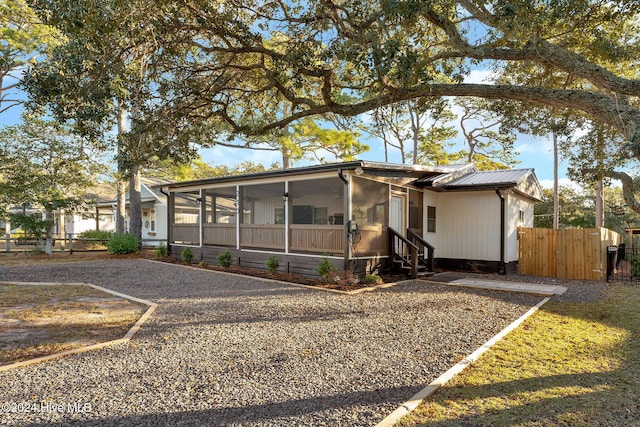 view of front of house featuring a sunroom