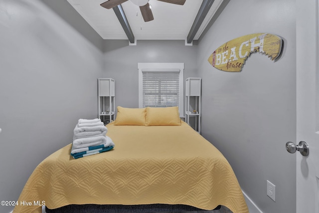 bedroom with ceiling fan and beamed ceiling