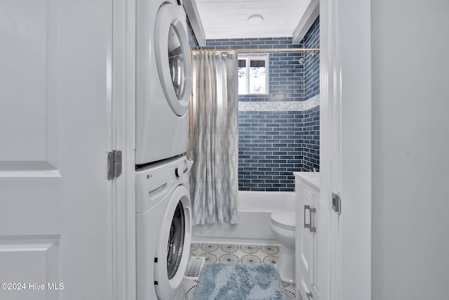 laundry area with stacked washing maching and dryer