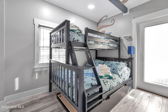 bedroom with light wood-type flooring and multiple windows