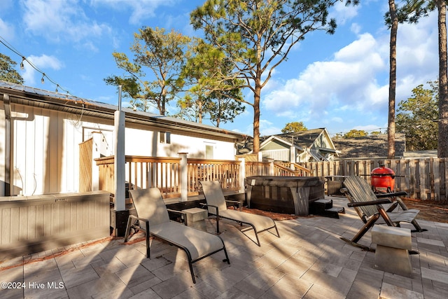 view of patio / terrace with a hot tub