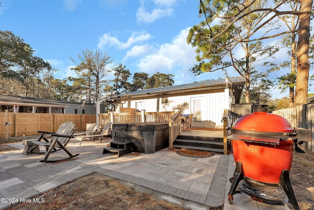 view of patio / terrace with a deck, a hot tub, and area for grilling