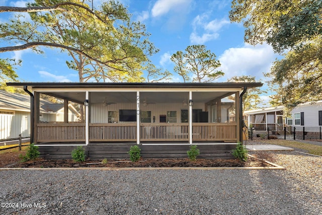 view of front of house featuring ceiling fan and a sunroom