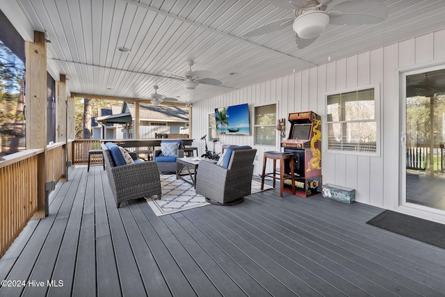 deck featuring ceiling fan and an outdoor living space