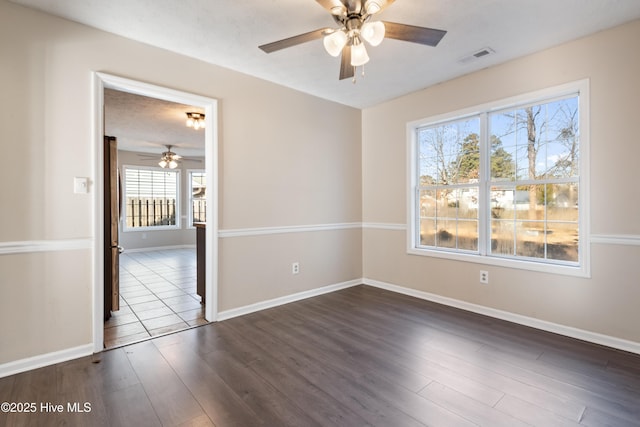 unfurnished room featuring ceiling fan, dark hardwood / wood-style floors, and a textured ceiling