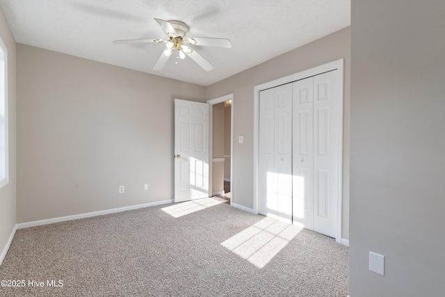 unfurnished bedroom with a closet, ceiling fan, and carpet flooring