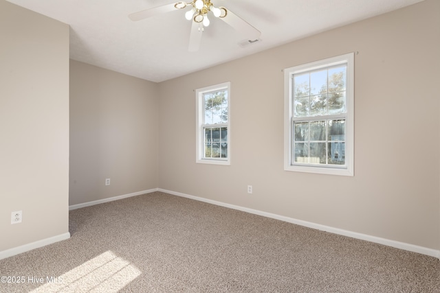 carpeted spare room with ceiling fan