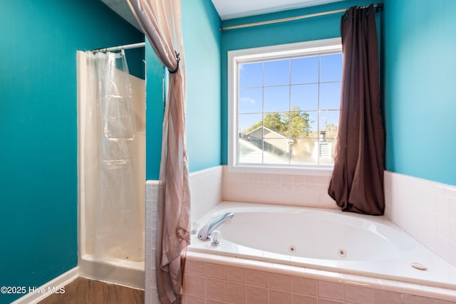 bathroom with hardwood / wood-style floors and separate shower and tub