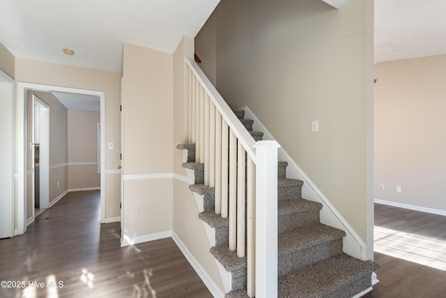 staircase with wood-type flooring