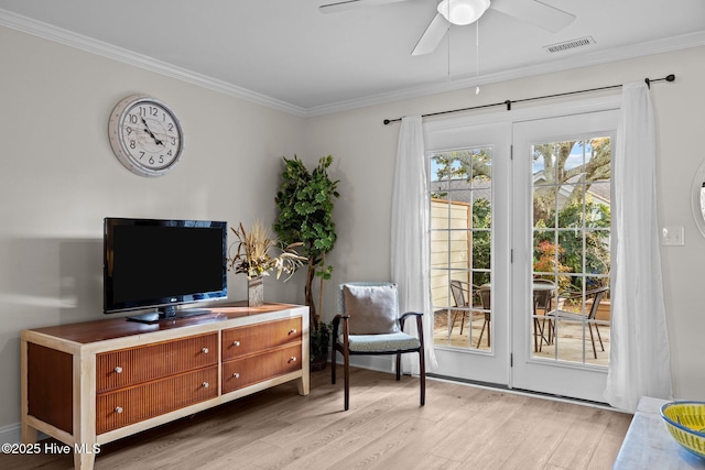 sitting room featuring light hardwood / wood-style floors, ceiling fan, and crown molding