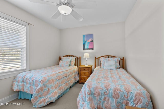 carpeted bedroom with multiple windows and ceiling fan