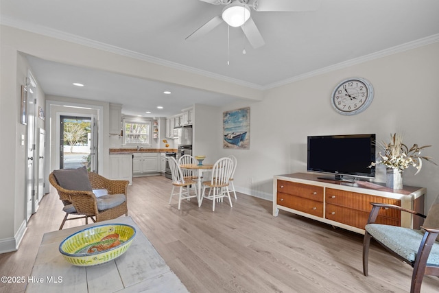 living room with light wood-type flooring, ceiling fan, and ornamental molding