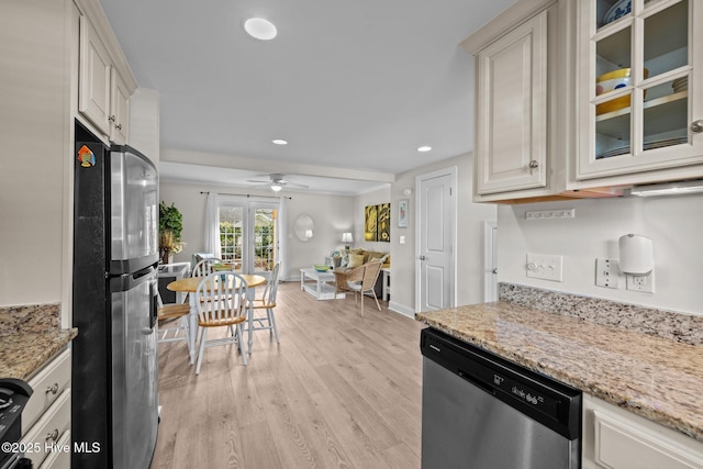 kitchen featuring light stone countertops, ceiling fan, french doors, appliances with stainless steel finishes, and light wood-type flooring