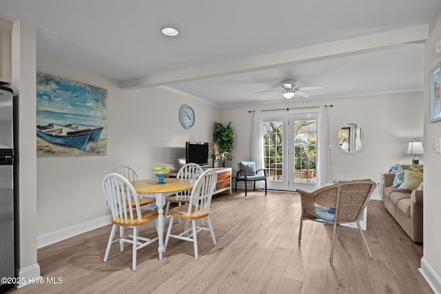 dining space with beamed ceiling, ceiling fan, ornamental molding, and light hardwood / wood-style flooring